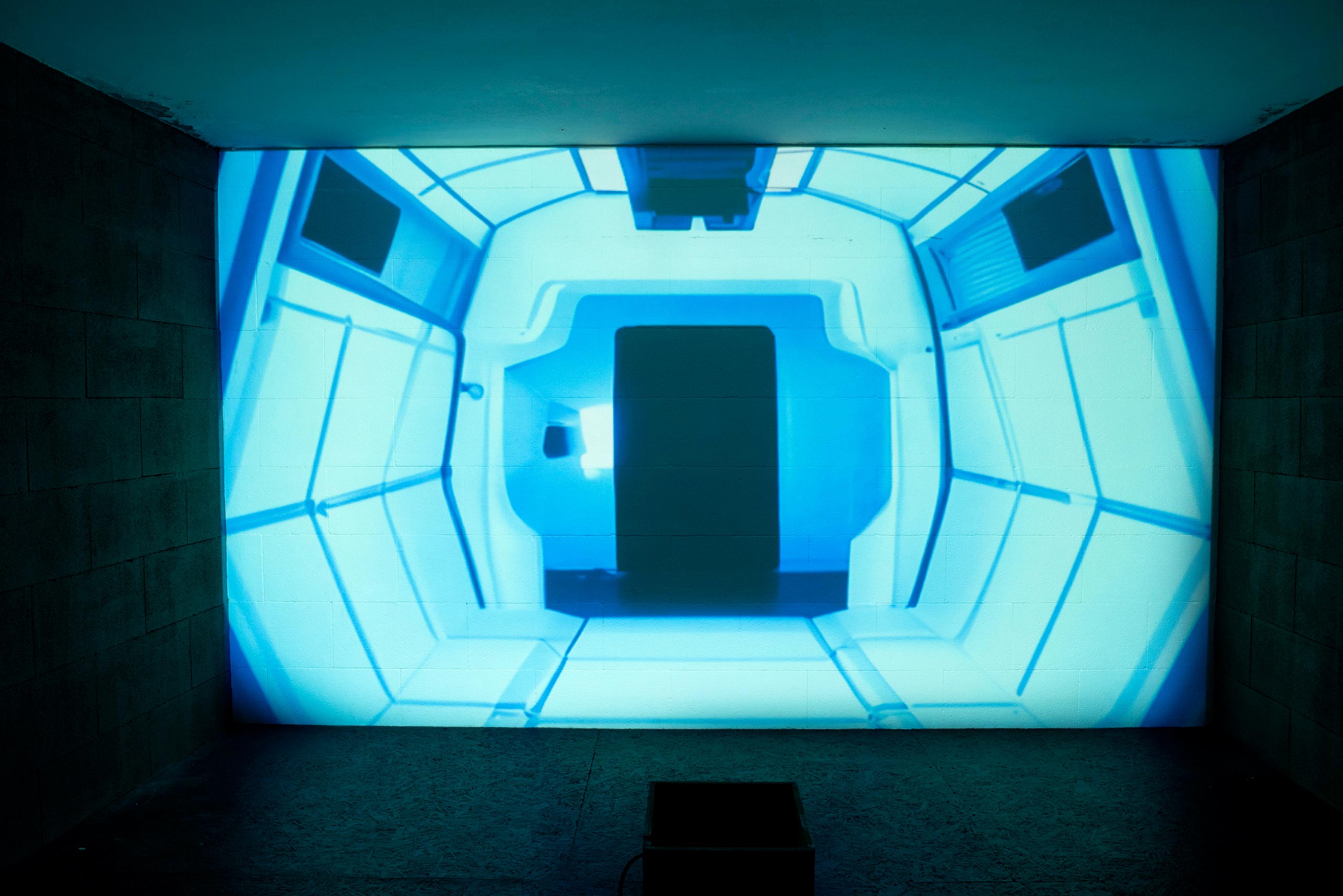 Interior of a spaceship with blue lights and a black door